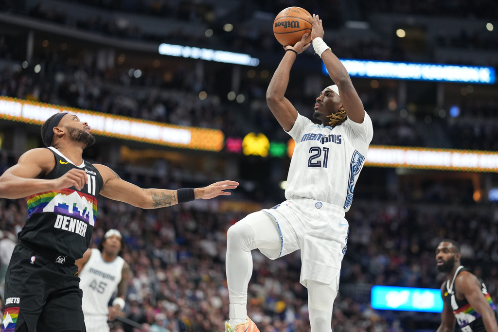 Memphis Grizzlies guard Jahmai Mashack, right, shoots for a basket over Denver Nuggets guard Bruce Brown in the first half of an NBA basketball game, Wednesday, Feb. 11, 2026, in Denver. (AP Photo/David Zalubowski)
