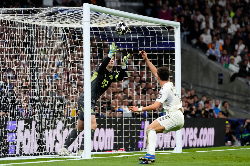 Bayern's goalkeeper Manuel Neuer makes a save before Real Madrid's Raul Asencio can score during the Champions League quarterfinal first leg soccer match between Real Madrid and Bayern Munich in Madrid, Spain, Tuesday, April 7, 2026. (AP Photo/Jose Breton)