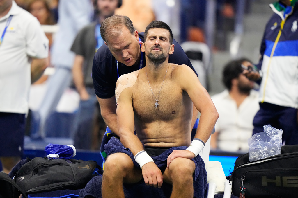 Novak Djokovic, of Serbia, gets medical treatment during the first round of the U.S. Open tennis championships against Mariano Navone, of Argentina, Sunday, Aug. 30, 2026, in New York. (AP Photo/Frank Franklin II)