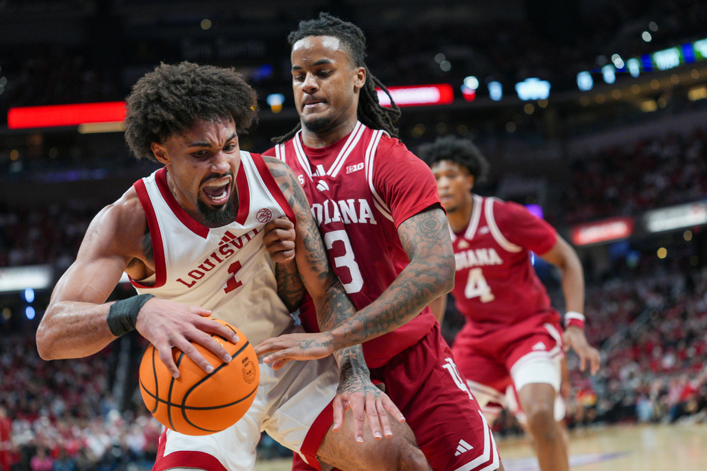 Louisville guard J'Vonne Hadley (1) works against Indiana guard Lamar Wilkerson (3) during an NCAA college basketball game in Indianapolis, Saturday, Dec. 6, 2025. (AP Photo/AJ Mast)