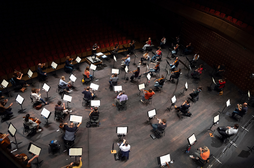 FILE - Chief Conductor Elim Chan, center top, conducts the Antwerp Symphony Orchestra through a rehearsal at the Queen Elisabeth Hall in Antwerp, Belgium, July 1, 2020. (AP Photo/Virginia Mayo, File)