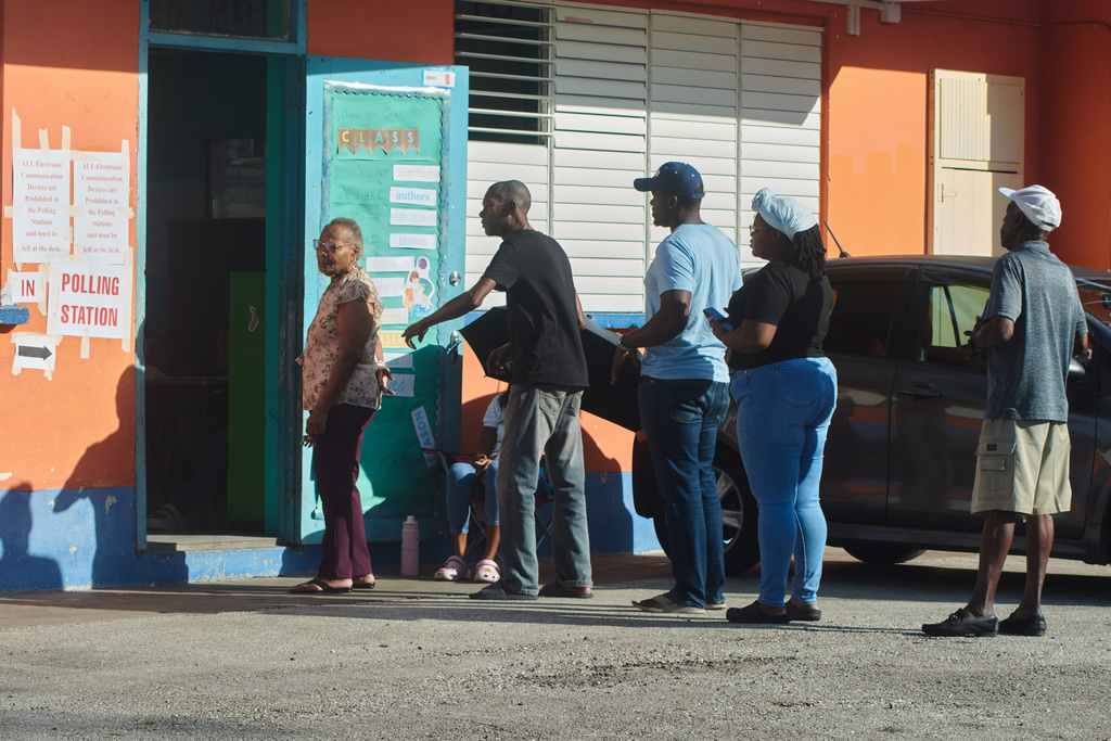 People line up to vote during the general election in Bridgetown, Barbados, Wednesday, Feb. 11, 2026. (AP Photo/Kerrie Eversley)