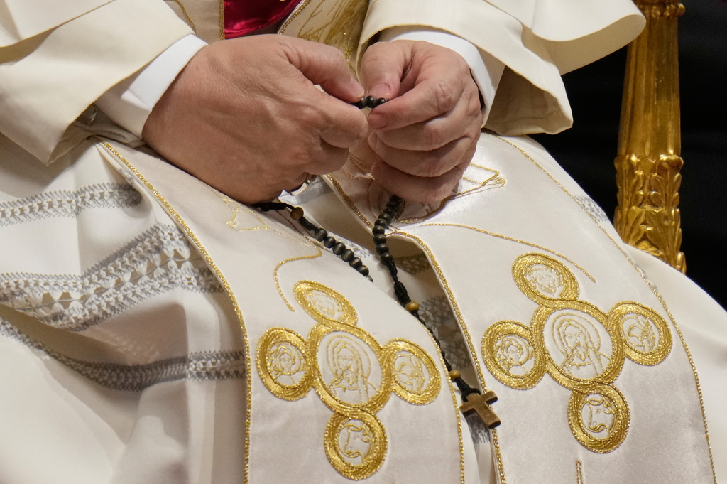 Pope Leo XIV holds a rosary as he leads a vigil for peace inside St. Peter's Basilica at the Vatican, Saturday, April 11, 2026. (AP Photo/Gregorio Borgia)