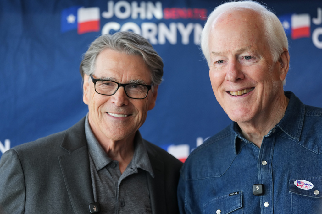 Sen. John Cornyn, R-Texas, right, is joined by former Texas Gov. Rick Perry, left, during a campaign stop in Austin, Texas, Tuesday, Feb. 17, 2026. (AP Photo/Eric Gay)