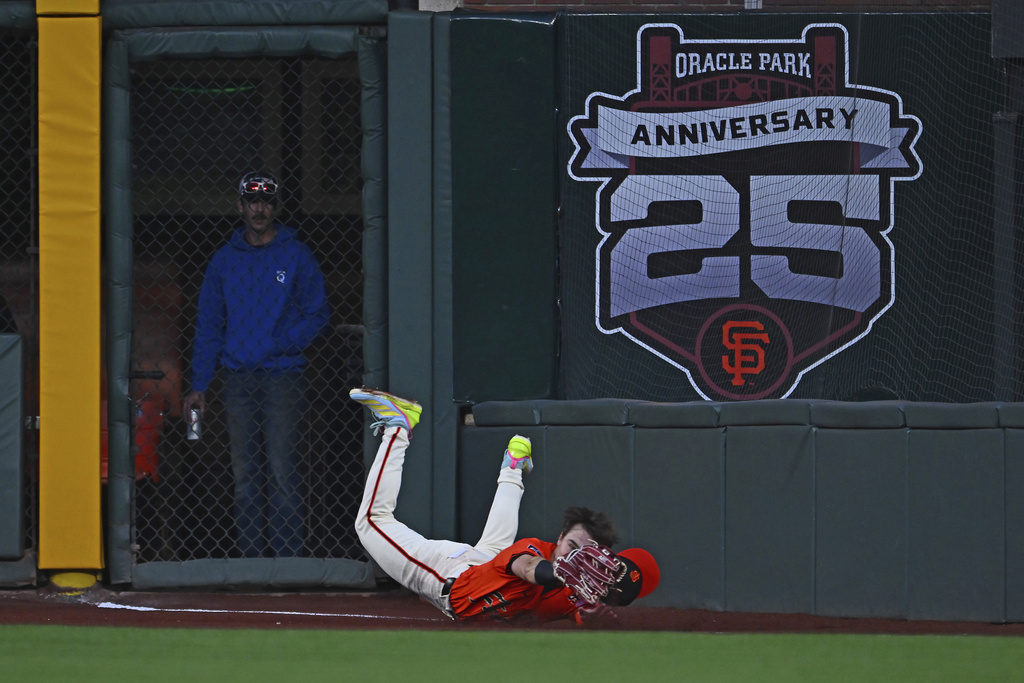 San Francisco Giants' Drew Gilbert dives to catch a ball hit by Washington Nationals' Jacob Young in the third inning of a baseball game in San Francisco, Friday, Aug. 8, 2025. (Jose Carlos Fajardo/Bay Area News Group via AP)