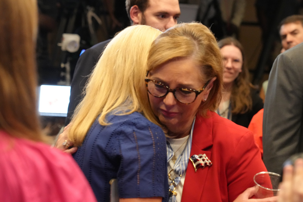 Sen. Darline Graham, R-S.C., right, receives a hug from Tara Spicer, her late brother's long-time campaign advisor, after winning a special Republican primary runoff to replace the Sen. Lindsey Graham, R-S.C., in the November general election, Tuesday, Aug. 25, 2026, in Columbia, S.C. (AP Photo/Meg Kinnard)