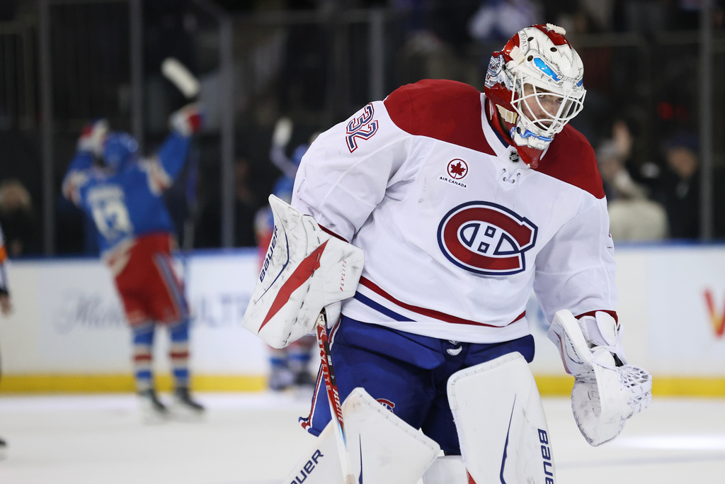 Montréal Canadiens goaltender Jacob Fowler (32) skates off the ice while the New York Rangers celebrate an overtime goal by J.T. Miller during an NHL hockey game, Saturday, Dec. 13, 2025, in New York. (AP Photo/Heather Khalifa)