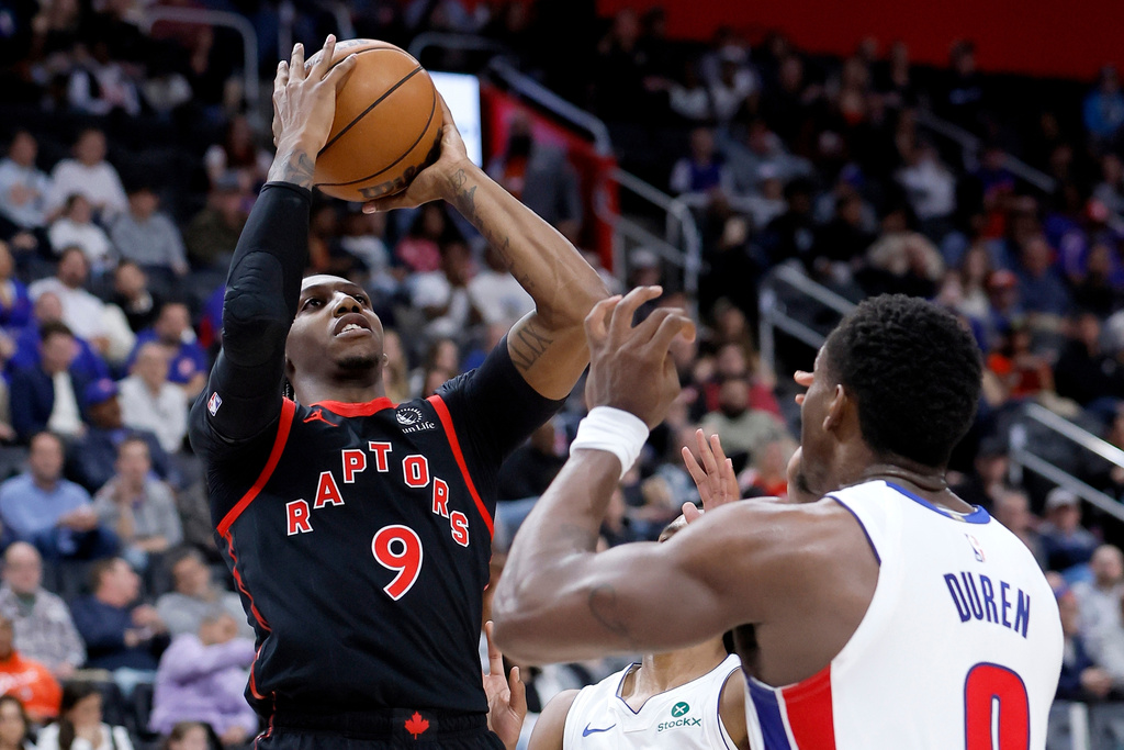 Toronto Raptors forward RJ Barrett (9) takes a shot against Detroit Pistons guard Daniss Jenkins, back, and center Jalen Duren (0) during the first half of an NBA basketball game Tuesday, March 31, 2026, in Detroit. (AP Photo/Duane Burleson)