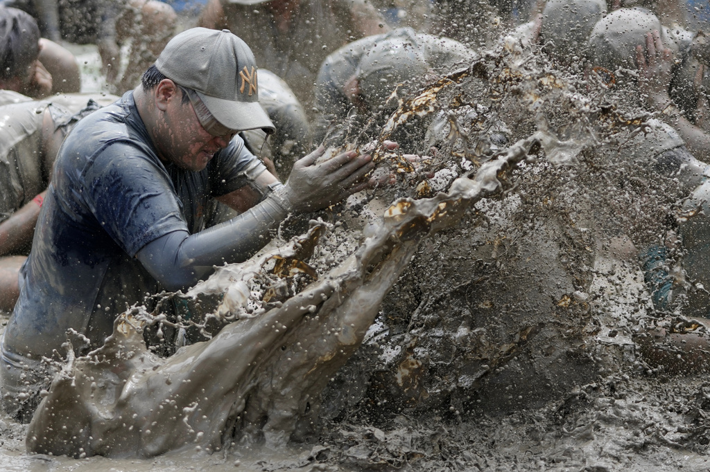 A participant plays in a mud pool during the Boryeong mud festival near a beach in Boryeong, South Korea, Saturday, July 25, 2026. (AP Photo/Lee Jin-man)