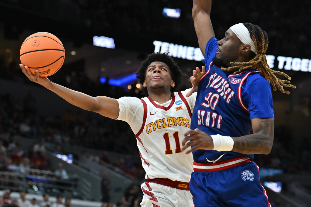 Iowa State's Dominick Nelson (11) heads to the basket as Tennessee State's Aaron Nkrumah (30) defends during the first half in the first round of the NCAA college basketball tournament, Friday, March 20, 2026, in St. Louis. (AP Photo/Ali Overstreet)