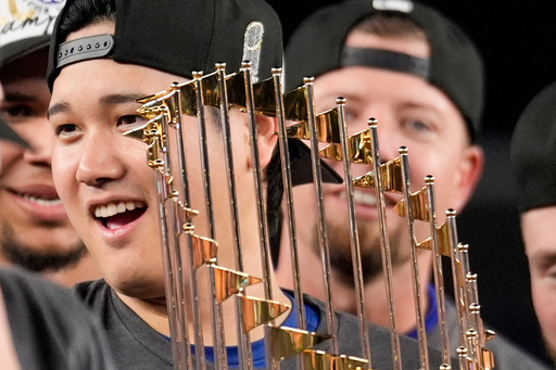 Los Angeles Dodgers' Shohei Ohtani celebrates with the trophy after their win against the New York Yankees in Game 5 to win the baseball World Series, Thursday, Oct. 31, 2024, in New York. (AP Photo/Ashley Landis) Los Angeles Dodgers' Shohei Ohtani celebrates with the trophy after their win against the New York Yankees in Game 5 to win the baseball World Series, Thursday, Oct. 31, 2024, in New York. (AP Photo/Ashley Landis)