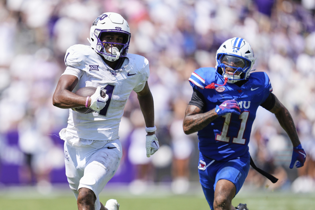TCU wide receiver Eric McAlister (1) sprints to the end zone for a touchdown after catching a pass as SMU safety Jaden Milliner-Jones (11) gives chase in the second half of an NCAA college football game, Saturday, Sept. 20, 2025, in Fort Worth, Texas. (AP Photo/Tony Gutierrez)