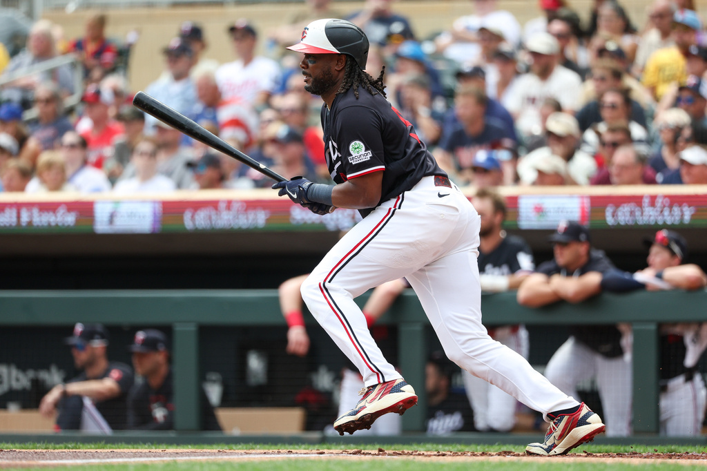 Minnesota Twins designated hitter Josh Bell hits an RBI single against the Chicago White Sox during the first inning of a baseball game, Sunday, Aug. 30, 2026, in Minneapolis. (AP Photo/Matt Krohn)