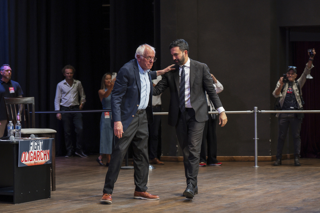 Sen. Bernie Sanders, I-Vt., left, and New York City mayoral candidate Zohran Mamdani hug during a town hall on Saturday, Sept, 6, 2025, in New York. (AP Photo/Olga Fedorova)