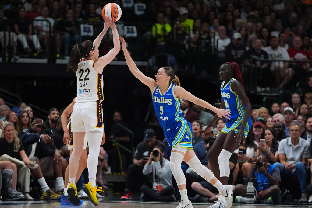 Indiana Fever guard Caitlin Clark (22) goes up to shoot against Dallas Wings guard Paige Bueckers (5) during the first half of a WNBA basketball game in Dallas, Thursday, Aug. 20, 2026. (AP Photo/LM Otero)