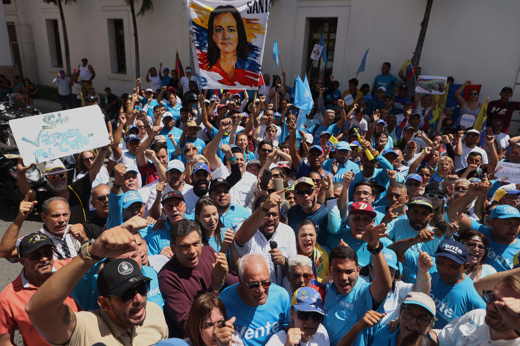 Supporters of opposition leader Maria Corina Machado rally to demand her return to the country and immediate elections in Los Teques, Venezuela, Sunday, Sept. 27, 2026. (AP Photo/Pedro Mattey)