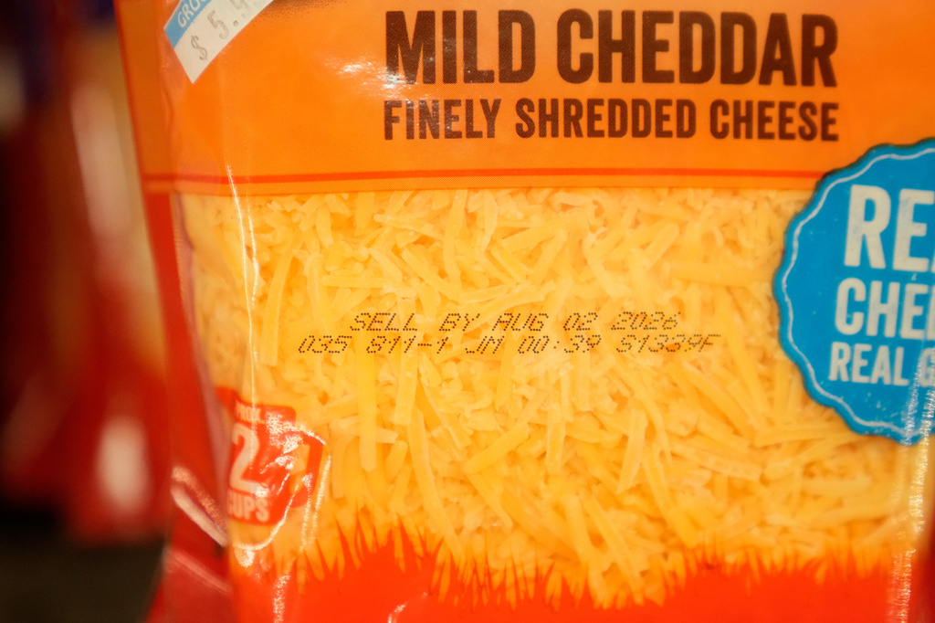 A Sell By date is stamped on package of cheese displayed at Park Plaza Fine Foods, Tuesday, June 30, 2026, in San Francisco. (AP Photo/Jeff Chiu)