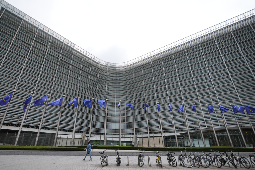 European Union flags flap in the wind outside EU headquarters in Brussels, prior to an announcement regarding Google, Thursday, July 23, 2026. (AP Photo/Virginia Mayo)