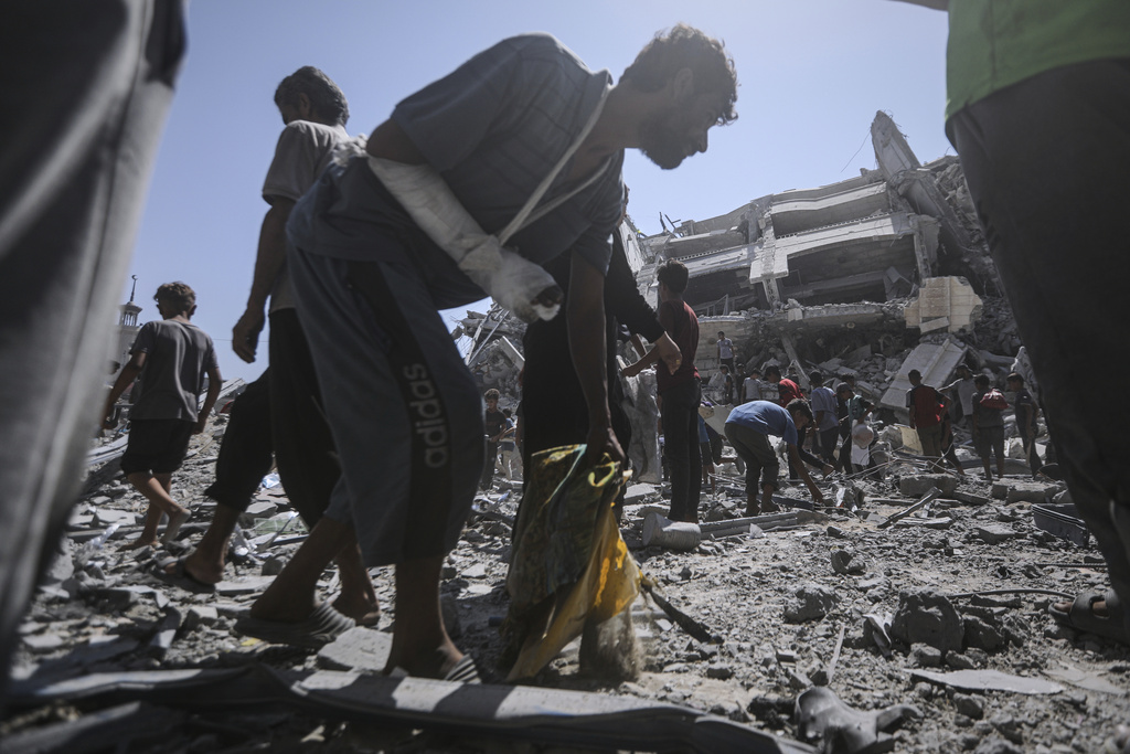 Palestinians inspect the damage after an Israeli army airstrike on a high-rise building in Gaza City, Friday, Sept. 5, 2025, after the Israeli army issued a prior warning. (AP Photo/Yousef Al Zanoun)