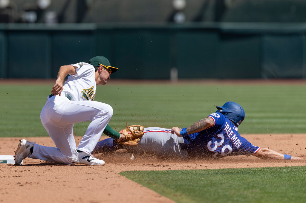 Athletics second baseman Alika Williams, left, tags out Texas Rangers' Cody Freeman (39) during the fourth inning of a baseball game Sunday, Aug. 16, 2026, in West Sacramento, Calif. (AP Photo/Sara Nevis)