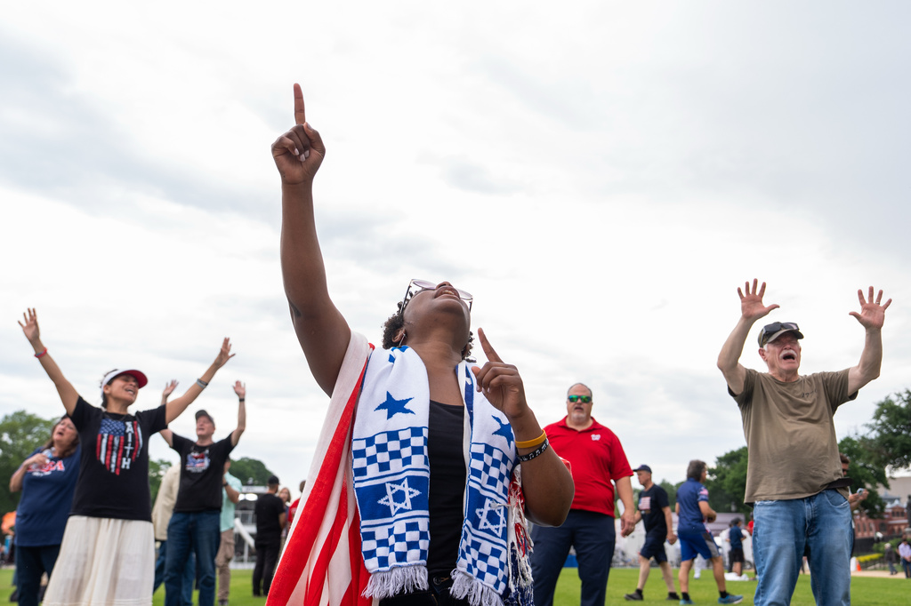 People worship to Christian music at Rededicate 250, a mostly conservative Christian prayer gathering in honor of the United States' 250th anniversary, on the National Mall, Sunday, May 17, 2026, in Washington. (AP Photo/Julia Demaree Nikhinson)