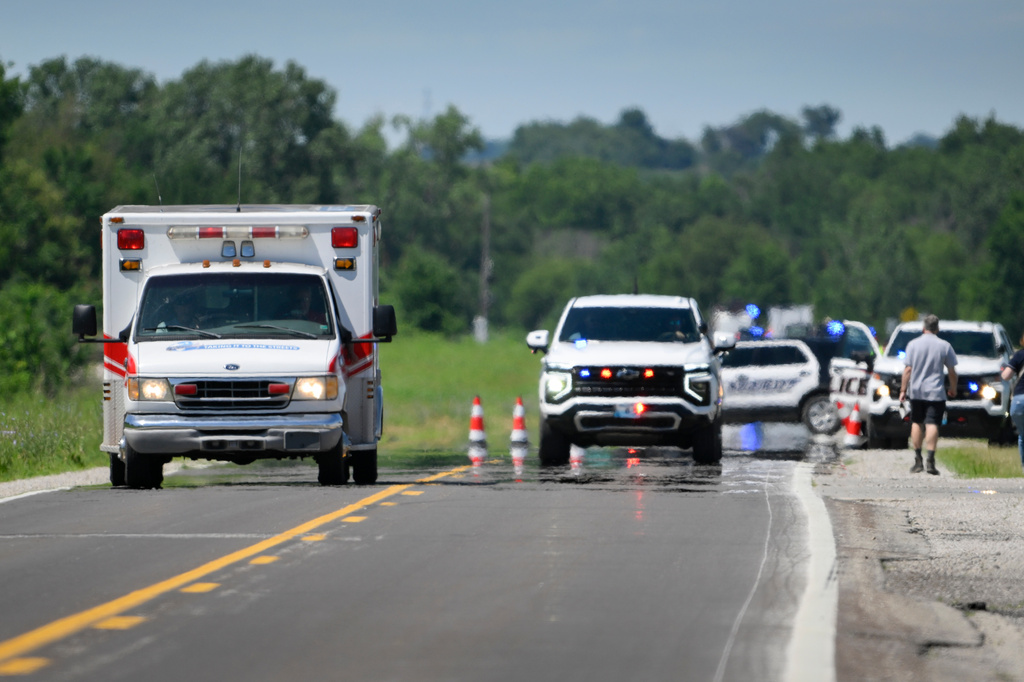 An emergency vehicle leaves the scene of the plane crash at the Butler Memorial Airport in Butler, Mo., Sunday, June 14, 2026. (AP Photo/Reed Hoffmann)
