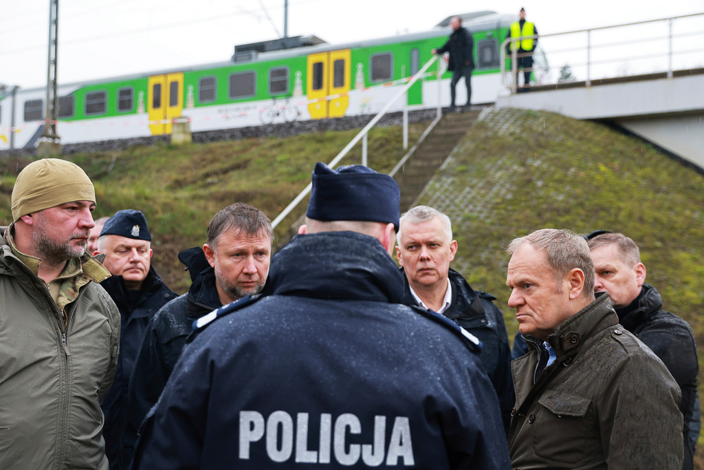 FILE - Polish Prime Minister Donald Tusk, right, visits the sabotaged rail line near Mika, Poland, Nov. 17, 2025. (AP Photo/KPRM, File)