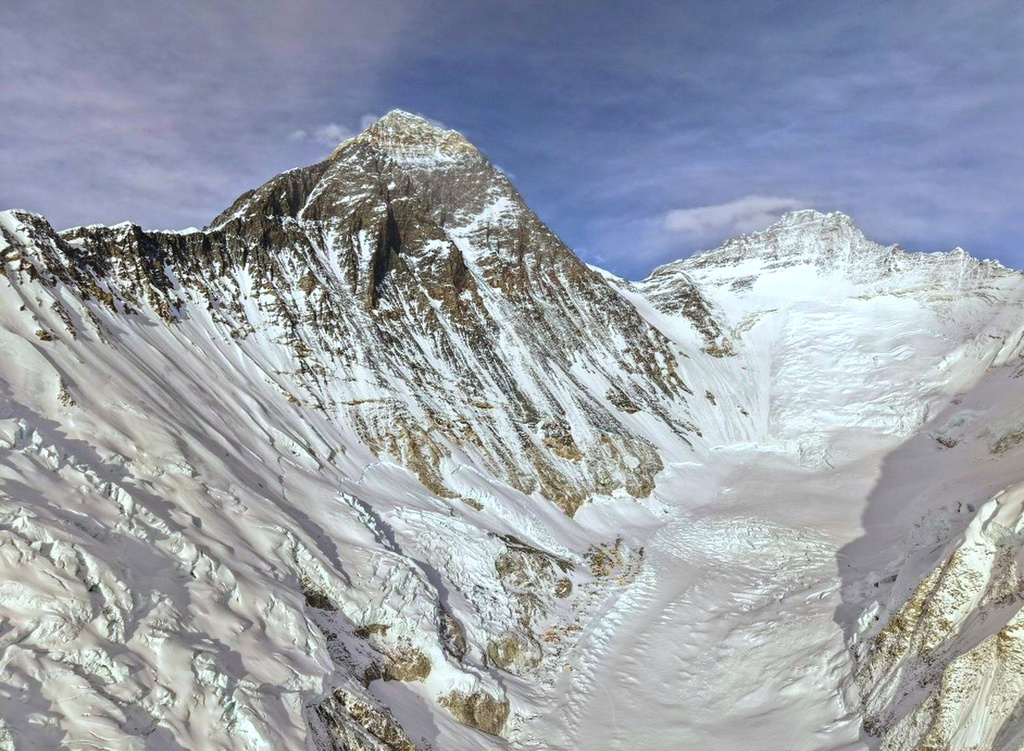 Mount Everest is seen, center left, from base camp in Nepal, Sunday, May 10, 2026. (AP Photo/Pasang Rinzee Sherpa)