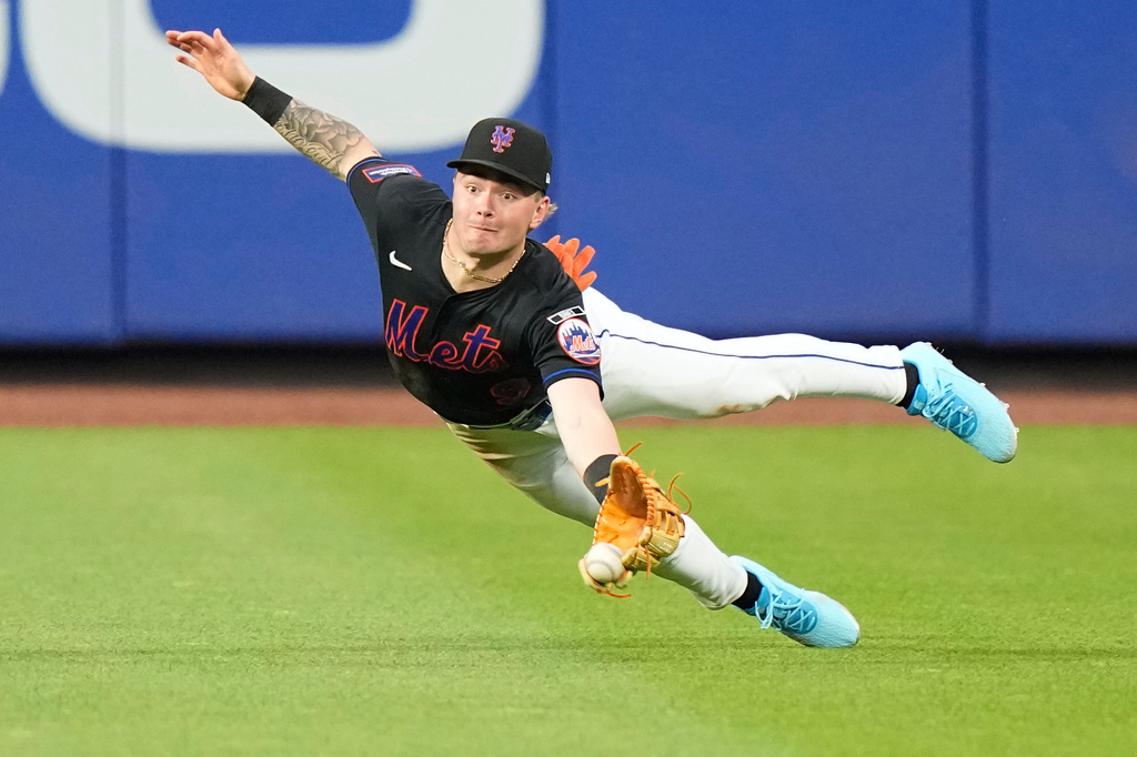New York Mets' A.J. Ewing attempts to catch a ball hit by Philadelphia Phillies' J.T. Realmuto for a double during the fourth inning of a baseball game Friday, June 26, 2026, in New York. (AP Photo/Frank Franklin II)