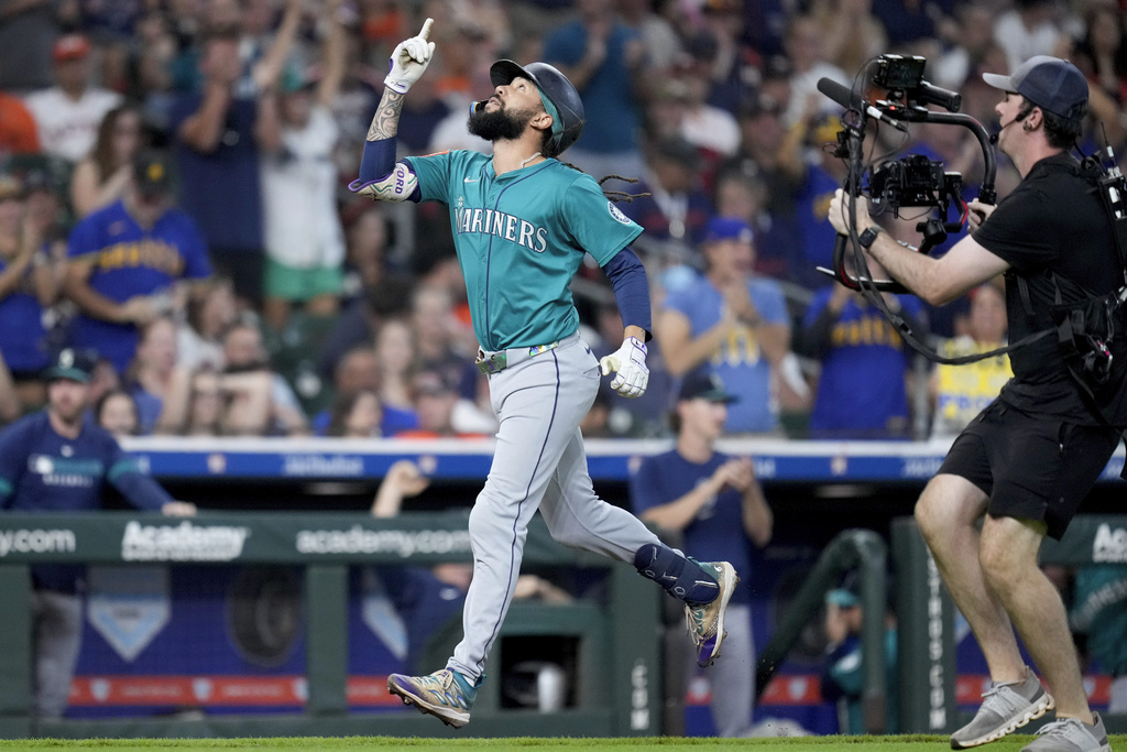 Seattle Mariners' J.P. Crawford reacts after hitting a grand slam against the Houston Astros during the second inning of a baseball game Sunday, Sept. 21, 2025, in Houston. (AP Photo/Eric Christian Smith)