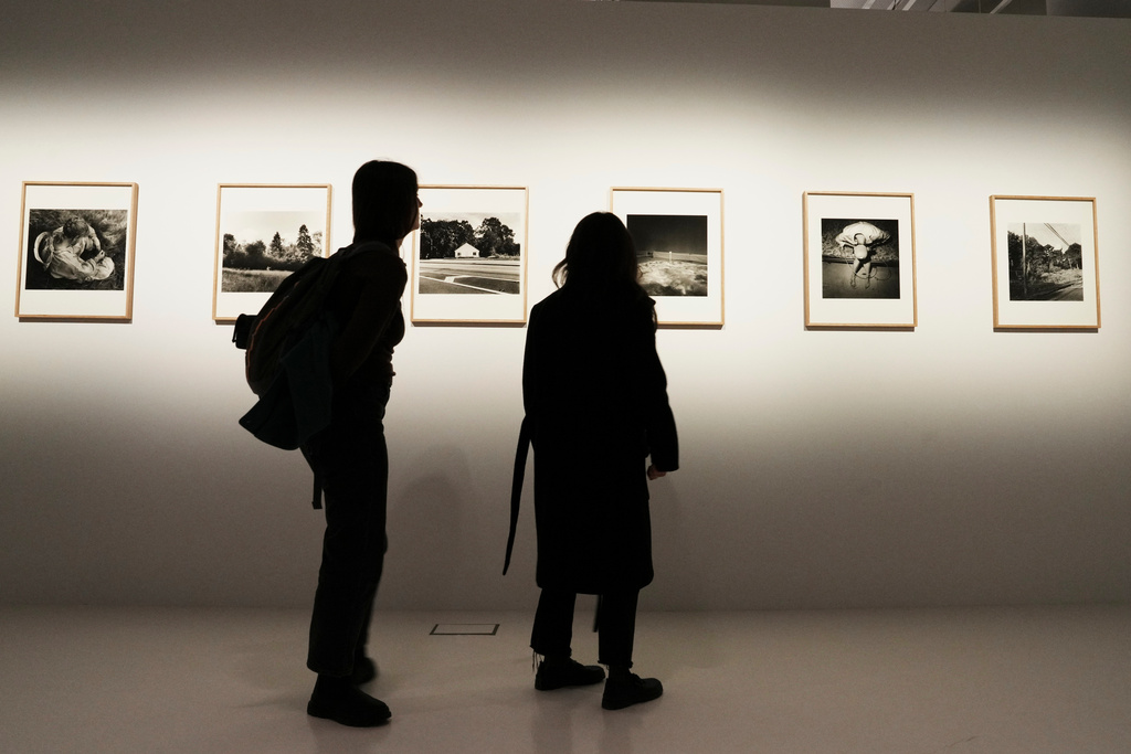 Visitors view photographs at an exhibition of images by Oscar nominated director Yorgos Lanthimos at Onassis Stegi in Athens, Greece, on Friday, March 6, 2026. (AP Photo/Thanassis Stavrakis)