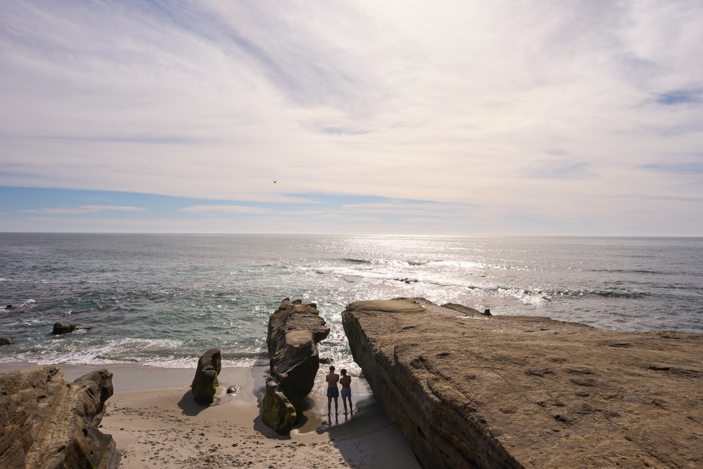 FILE - Two boys take a break from swimming in the Pacific Ocean at Windansea Beach under sunny skies and warm weather, Tuesday, Feb. 24, 2026, in San Diego. (AP Photo/Gregory Bull, File)
