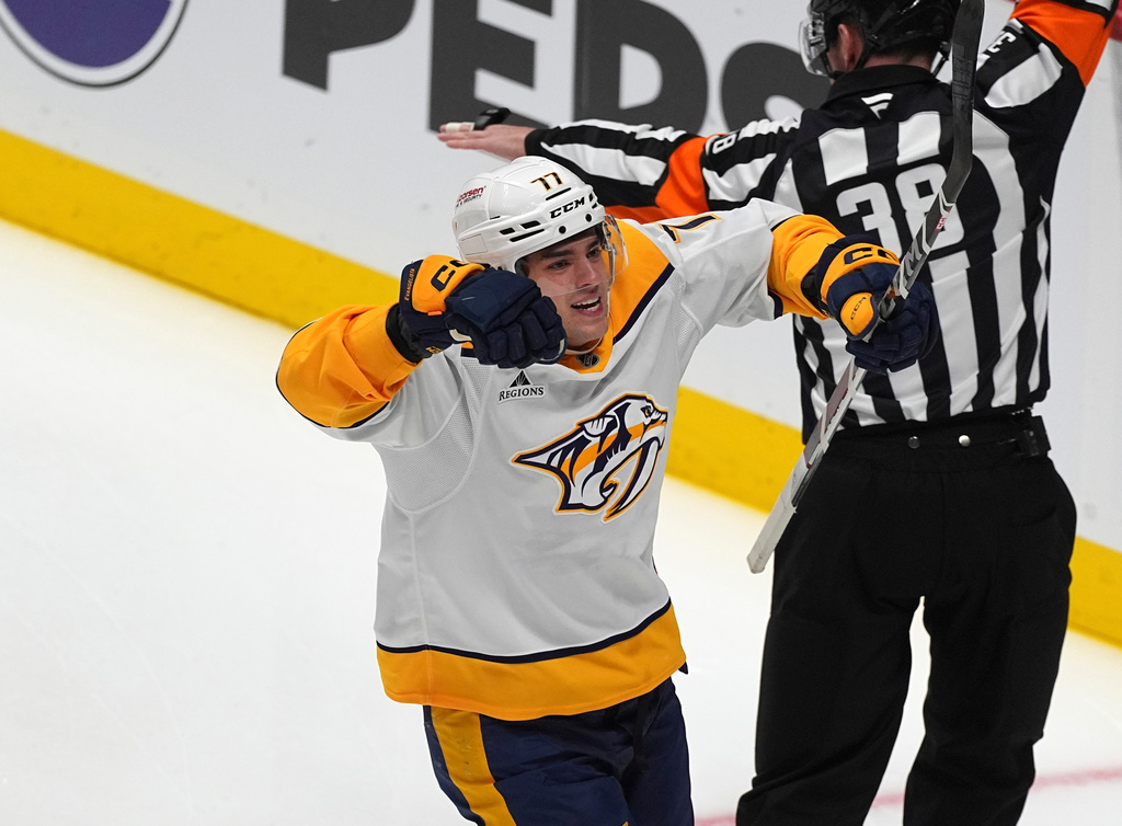 FILE - Nashville Predators right wing Luke Evangelista (77) celebrates after scoring a goal in the first period of an NHL hockey game, on Nov. 11, 2024, in Denver. (AP Photo/David Zalubowski, File)