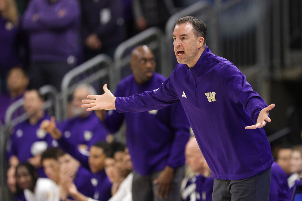 FILE - Washington head coach Danny Sprinkle reacts during the first half of an NCAA college basketball game, Jan. 17, 2026, in Seattle. (AP Photo/Jason Redmond, File)