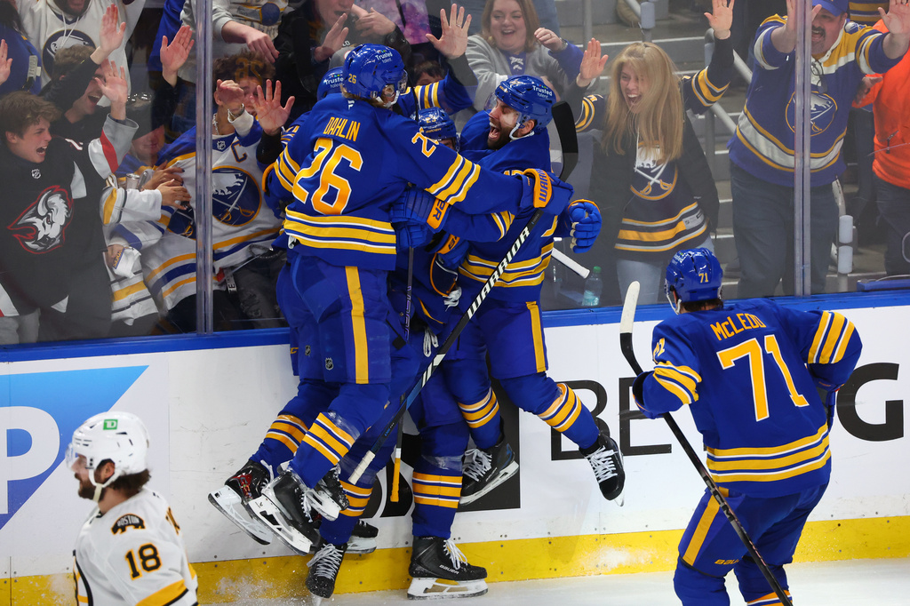 Buffalo Sabres players celebrate a goal by defenseman Mattias Samuelsson (23) during the third period in Game 1 of a first-round NHL hockey Stanley Cup playoff series against the Boston Bruins, Sunday, April 19, 2026, in Buffalo, N.Y. (AP Photo/Jeffrey T. Barnes)