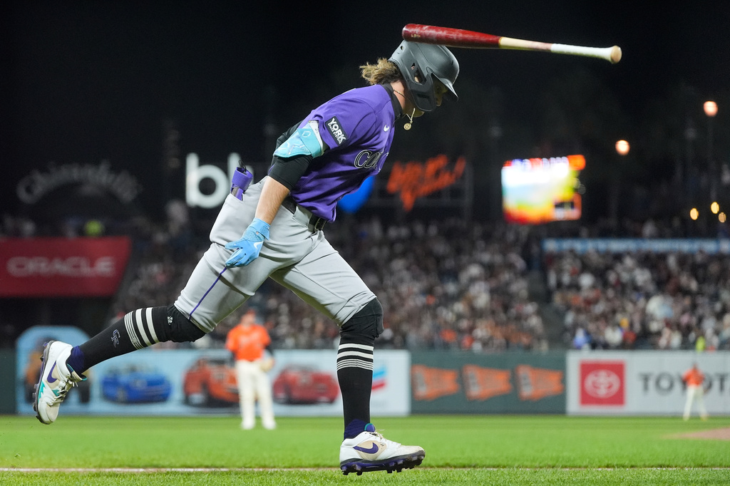 Colorado Rockies' Zac Veen flips his bat after hitting a two-run home run against the San Francisco Giants during the sixth inning of a baseball game, Friday, Aug. 14, 2026, in San Francisco. (AP Photo/Jeff Chiu)