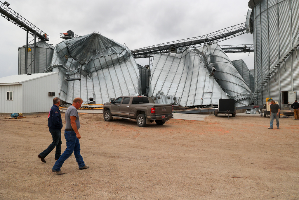 North Dakota Governor Kelly Armstrong walks by silos damaged by an EF5 tornado in Enderlin, N.D., on June 25, 2025. (North Dakota Governor's Office via AP)