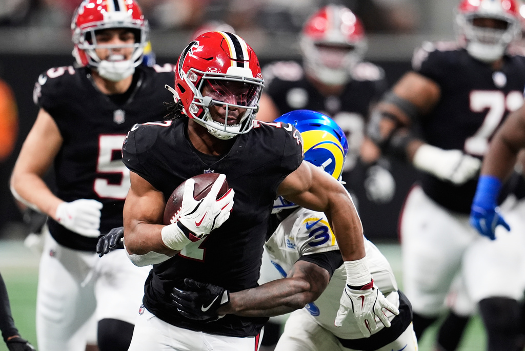 Atlanta Falcons running back Bijan Robinson (7) carries for a long gain against Los Angeles Rams safety Kam Curl (3) in the second half of an NFL football game, Monday, Dec. 29, 2025, in Atlanta. (AP Photo/Mike Stewart)