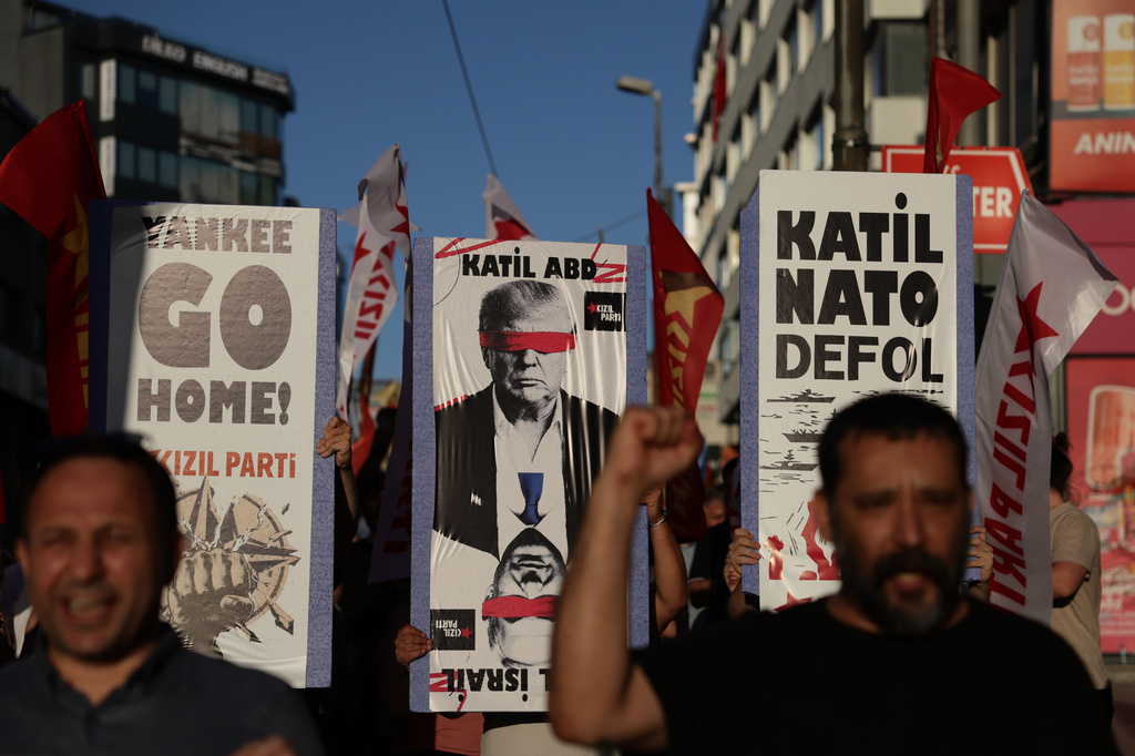 A protestor holds a sign, center, which reads "killer USA", and another holds a sign, right, which reads "killer Nato out" during a demonstration ahead of the NATO Summit in Istanbul, Turkey, Sunday, July 5, 2026. (AP Photo/Erdem Sahin)