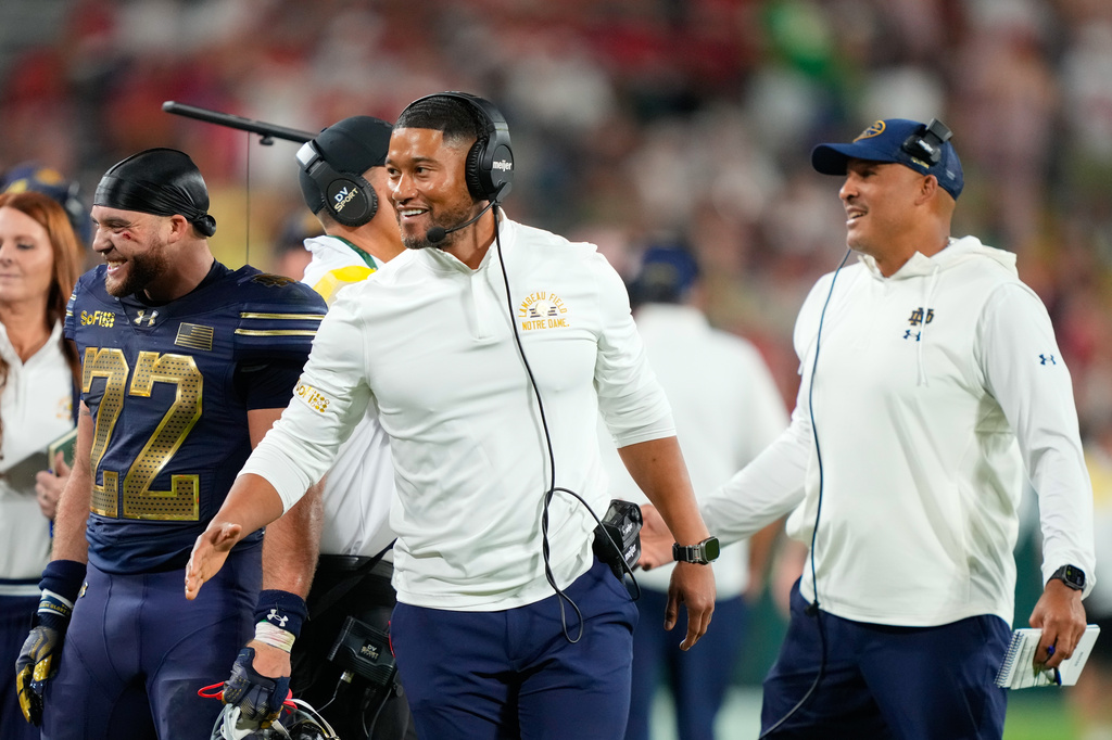 Notre Dame head coach Marcus Freeman, center, looks on during the second half of an NCAA college football game against Wisconsin Sunday, Sept. 6, 2026, in Green Bay, Wis. (AP Photo/Kayla Wolf)