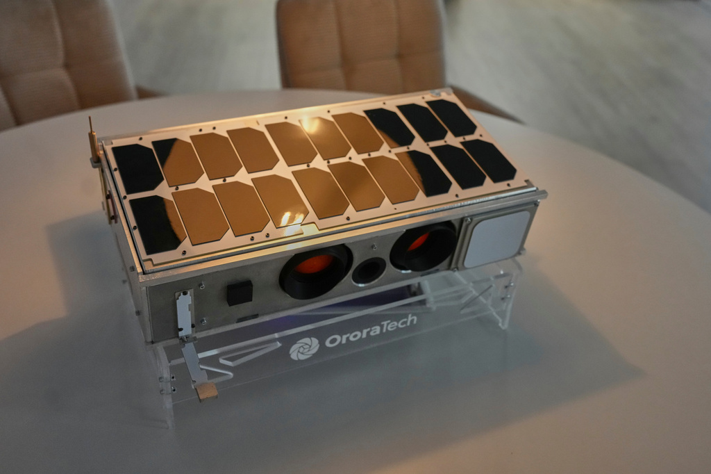 A replica of an OroraTech wildfire-detection satellite is displayed at the company's facilities in Athens, Greece, on Thursday, June 18, 2026, as Greece integrates a new constellation of wildfire-detection satellites into its national firefighting system. (AP Photo/Petros Giannakouris)