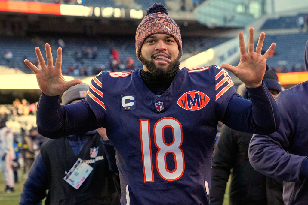 Chicago Bears quarterback Caleb Williams (18) celebrates as he runs off the field after an NFL football game against the Cleveland Browns in Chicago, Sunday, Dec. 14, 2025. (AP Photo/Nam Y. Huh)