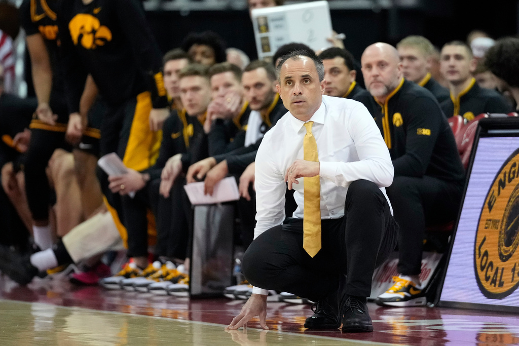 Iowa head coach Ben McCollum, front, looks on during the first half of an NCAA college basketball game against Wisconsin, Sunday, Feb. 22, 2026, in Madison, Wis. (AP Photo/Kayla Wolf)