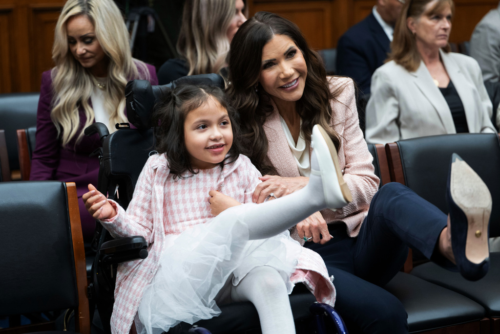 Homeland Security Secretary Kristi Noem poses for a photo with Dalilah Coleman, who was injured in a 2024 car crash, during a short hearing break in a House Judiciary Committee hearing on the oversight of the Department of Homeland Security, Wednesday, March 4, 2026 in Washington. (AP Photo/Kevin Wolf)