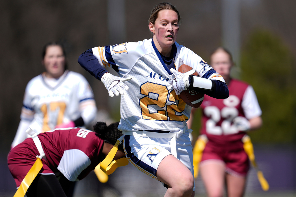 FILE - Augustana University and Concordia University, St. Paul players compete during a women's college flag football game, April 7, 2025, in St. Paul. Minn. (AP Photo/Abbie Parr, File)