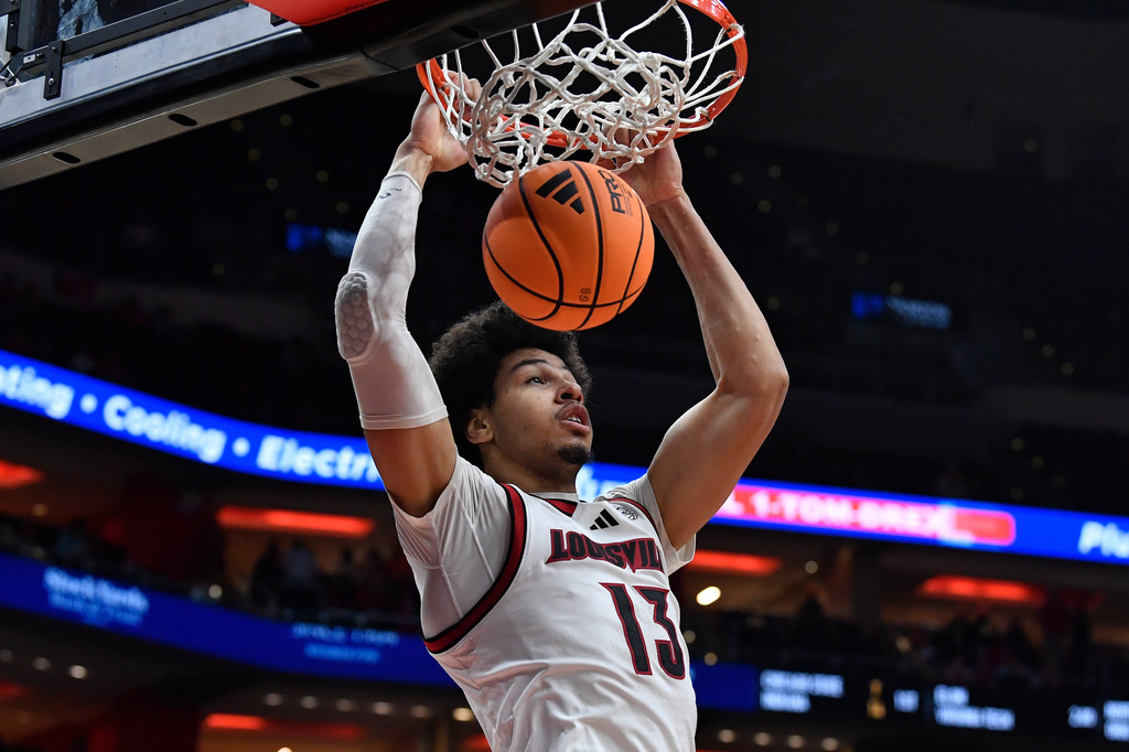 Louisville forward Sananda Fru (13) dunks during the second half of an NCAA college basketball game against Montana in Louisville, Ky., Saturday, Dec. 20, 2025. (AP Photo/Timothy D. Easley)