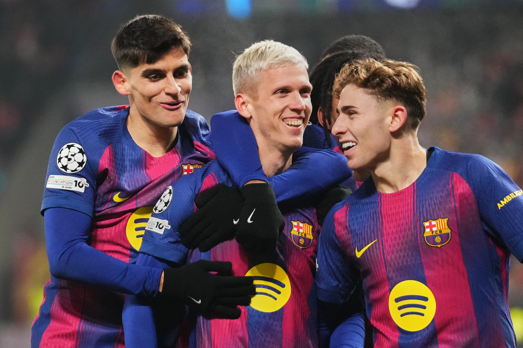 Barcelona's Dani Olmo, center, celebrates with his teammates after scoring his side's third goal during the Champions League opening phase soccer match between Slavia Prague and Barcelona in Prague, Czech Republic, Wednesday, Jan. 21, 2026. (AP Photo/Petr David Josek)