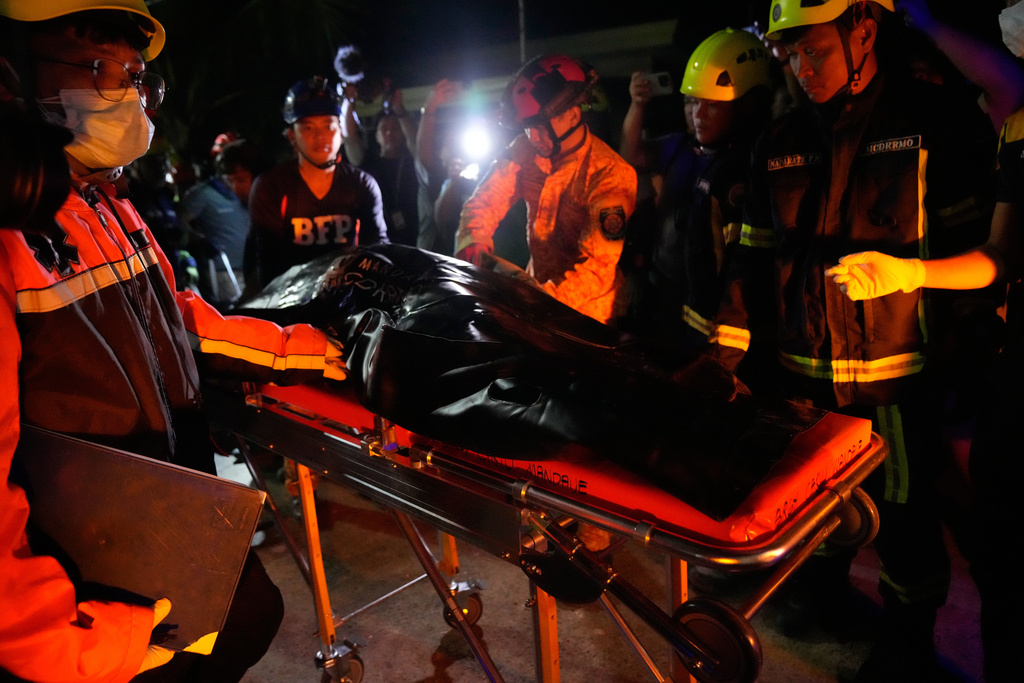 Rescuers bring down a body they recovered from the ruins of a collapsed building, Wednesday, Oct. 1, 2025 after a strong earthquake struck Bogo city, Cebu Province, Central Philippines. (AP Photo/Aaron Favila)