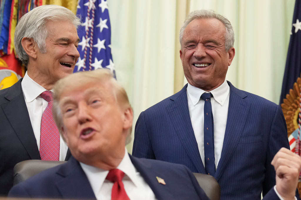 President Donald Trump speaks as Health and Human Services Secretary Robert F. Kennedy Jr., right, and Mehmet Oz, administrator of the Centers for Medicare & Medicaid Services, listen during an event about healthcare in the Oval Office of the White House, Friday Sept. 18, 2026, in Washington. (AP Photo/Jacquelyn Martin)
