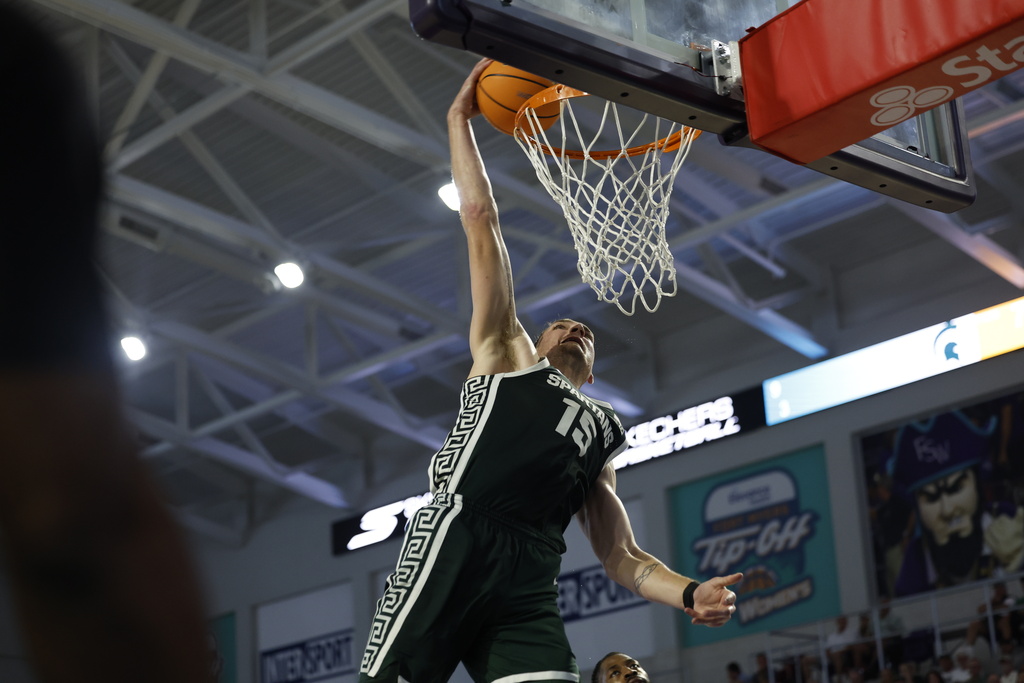 Michigan State center Carson Cooper dunks the ball against East Carolina during the second half of an NCAA college basketball game, Tuesday, Nov. 25, 2025 in Ft. Myers, Fla. (AP Photo/Scott Audette)